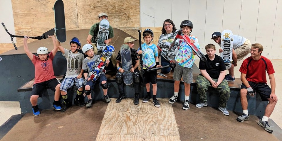 A group of young riders with boards and helmets at a Battleground summer camp
