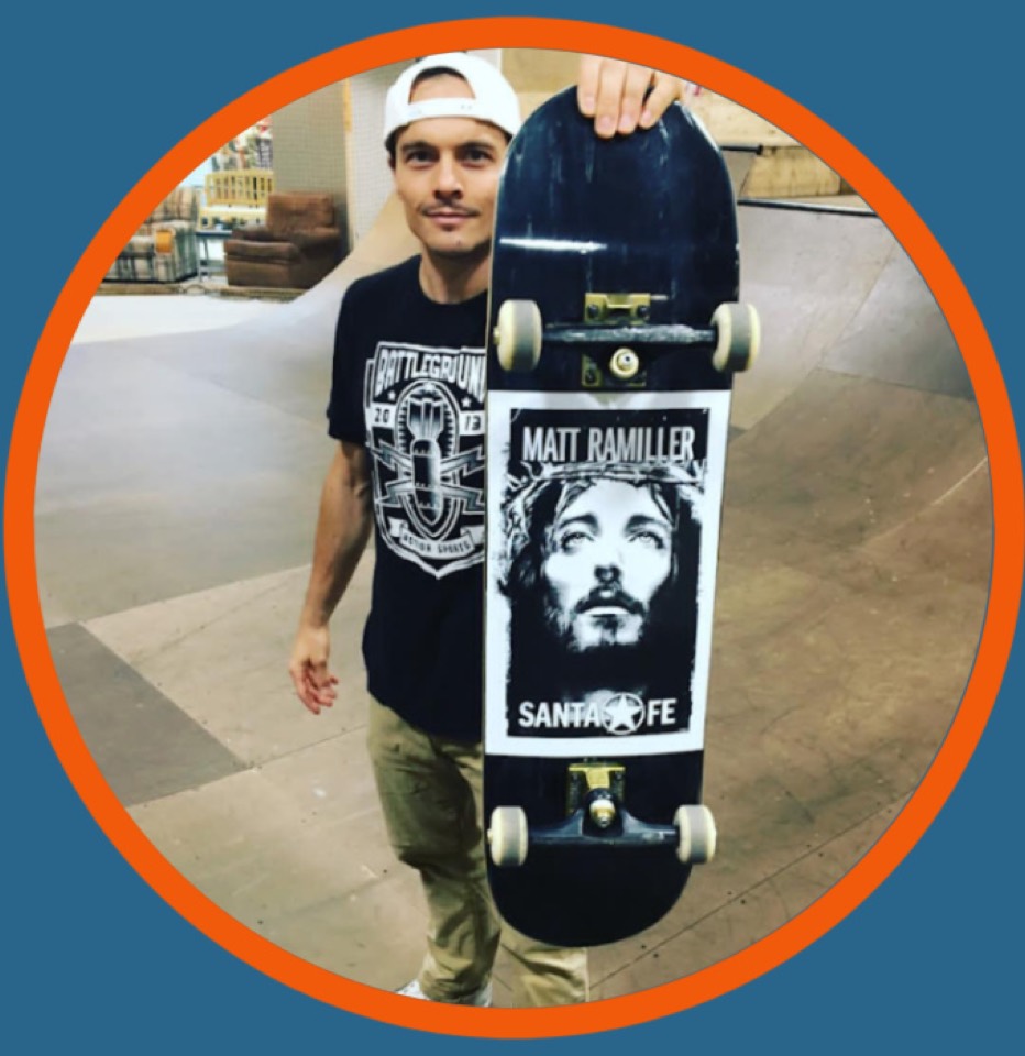 Matt Ramiller holding a skateboard inside the park